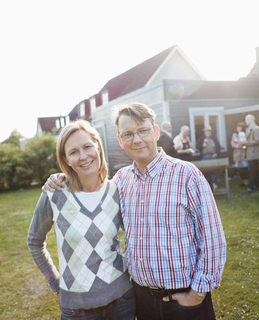 portrait-of-couple-in-back-yard-against-house-2023-11-27-04-52-30-utc